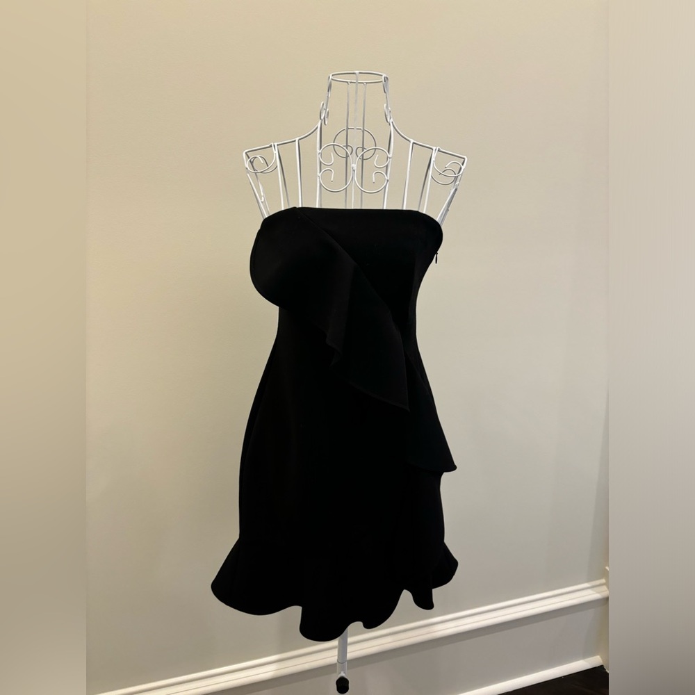 Likely strapless black mini dress; size small/xs